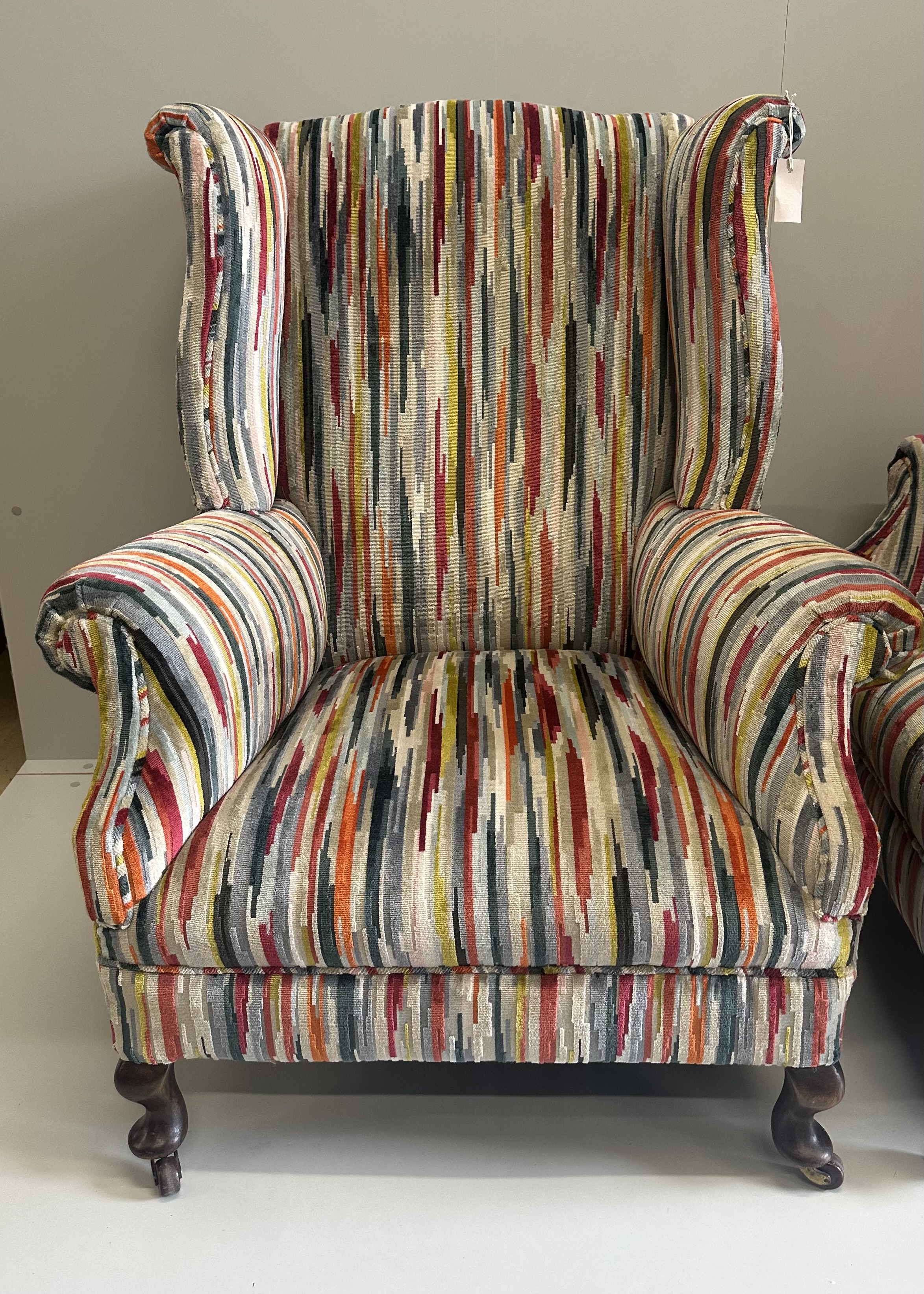A pair of Edwardian wing armchairs, upholstered in contemporary striped fabric, width 74cm, depth 78cm, height 104cm